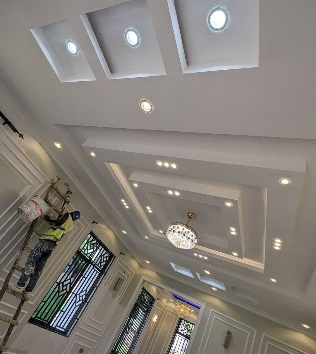 The full ceiling composition seen from below - gypsum work mid-finish - bespoke joinery by Royalwoods Interiors, Nairobi