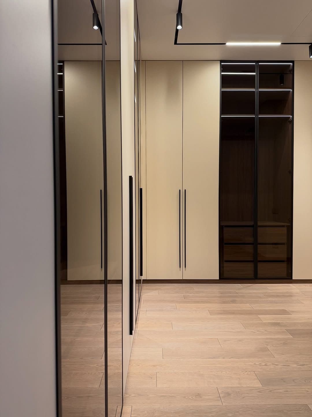 Full-height mirror column meeting bronze-glass wardrobe doors - bespoke joinery by Royalwoods Interiors, Nairobi