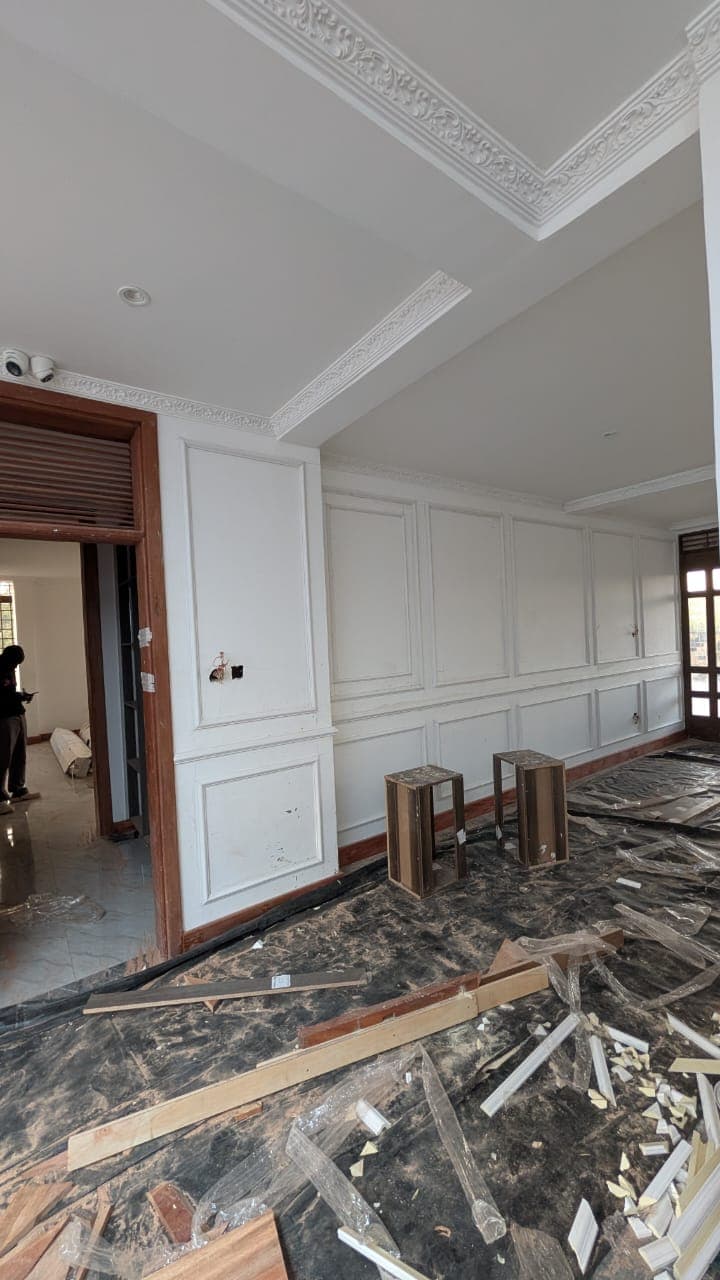 Full-height classical wall panelling and wainscoting in a Runda living room
